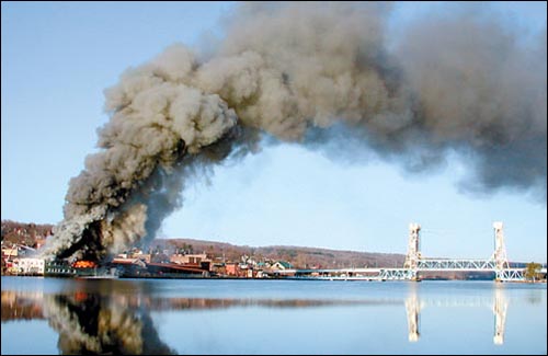 Smoke from the burning Gundlach Champion building casts a shadow over the Houghton waterfront on April 24. Ryan Olson-Daily Mining Gazette